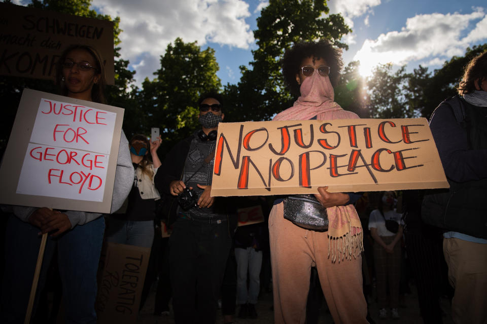 In this picture taken on Saturday, May 30, 2020 participants protest in a rally against the violent death of African-American George Floyd by a white policeman have gathered in front of the US embassy. After weeks of corona restrictions, there will no longer be a limited number of participants at demonstrations in Berlin starting this weekend. (Christoph Soeder/dpa via AP)