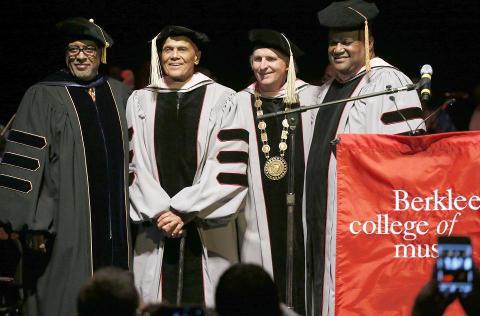 Harry Belafonte, center left, stands with Berklee College of Music President Roger H. Brown, center right, after receiving an honorary doctor of music degree at the Berklee Performance Center in Boston, Thursday, March 6, 2014. (AP Photo/Michael Dwyer)