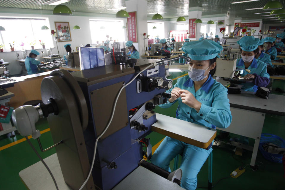 Employees assemble leather shoes at the Wonsan Leather Shoes Factory in Wonsan, Kangwon Province, North Korea, on Oct. 28, 2020. North Korea is staging an “80-day battle,” a propaganda-heavy productivity campaign meant to bolster its internal unity and report greater production in various industry sectors ahead of a ruling party congress in January. (AP Photo/Jon Chol Jin)