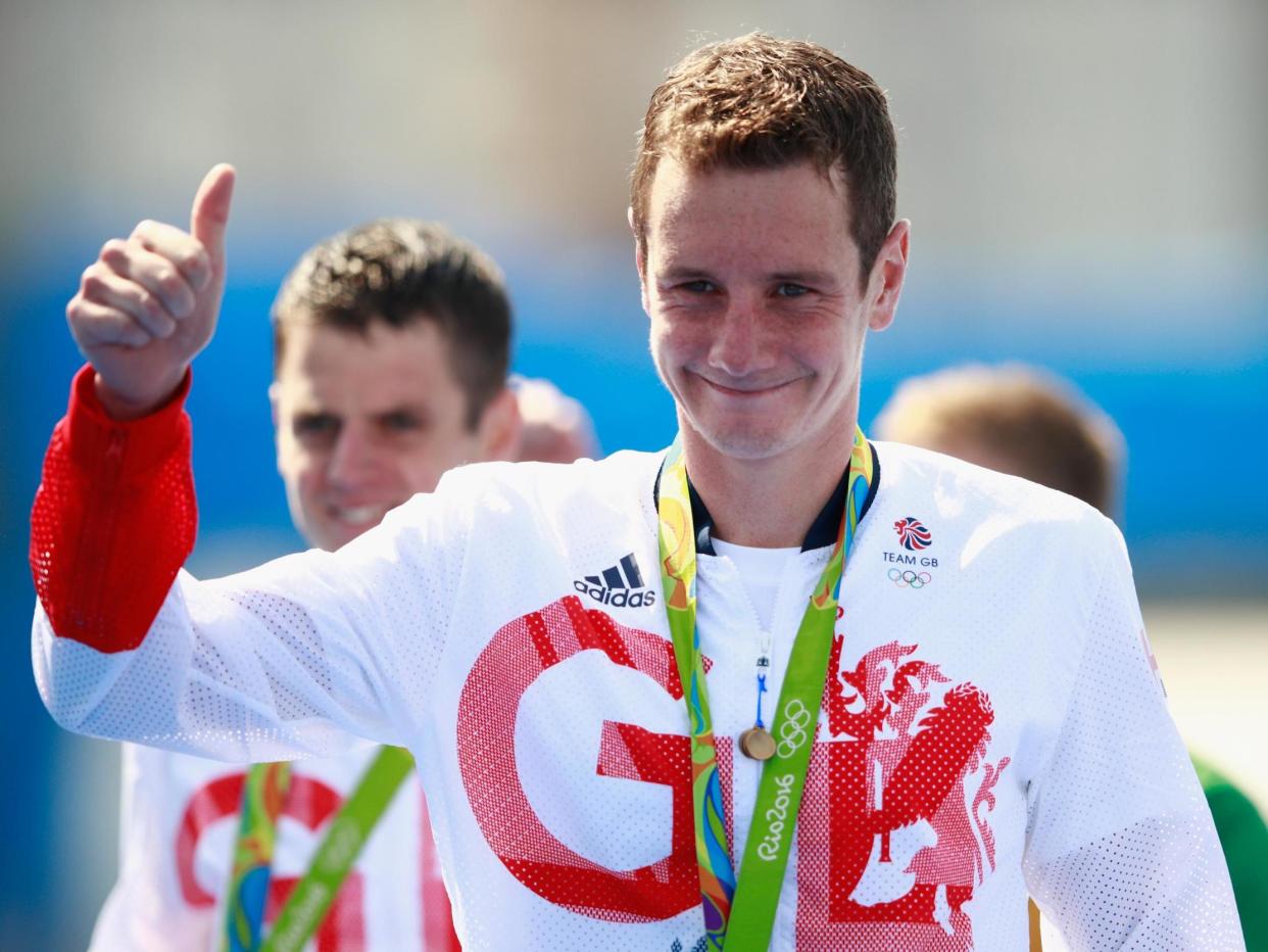 Gold medaltist Alistair Brownlee of Great Britain celebrates on the podium: Getty Images