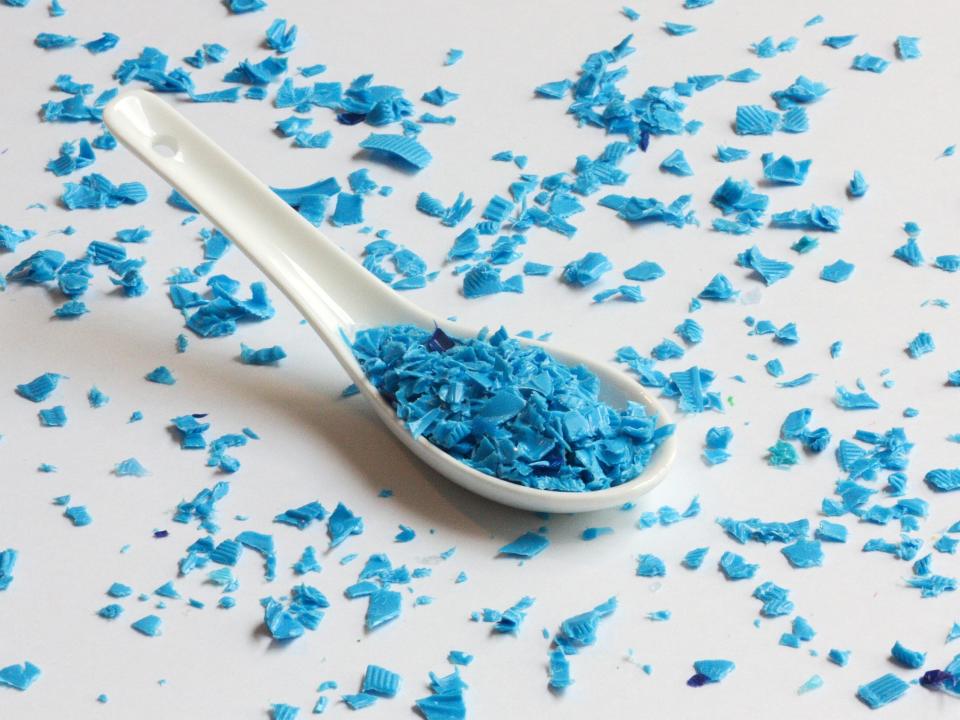 soup spoon filled with blue shredded plastic