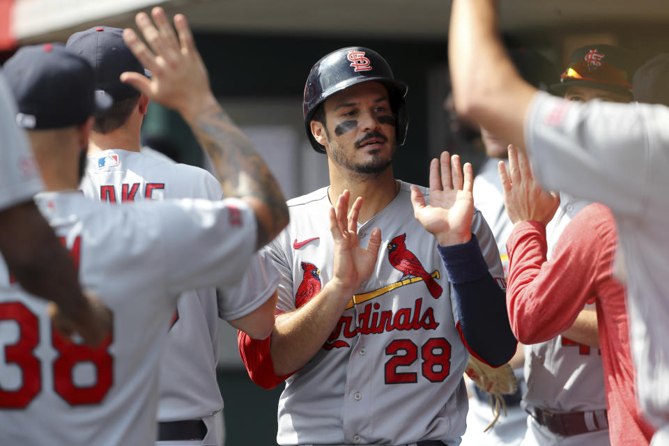 St. Louis Cardinals' Nolan Arenado (28) is congratulated by teammates after scoring during the fifth inning of a baseball game against the Cincinnati Reds, Sunday Sept. 10, 2023, in Cincinnati. (AP Photo/Joe Maiorana)