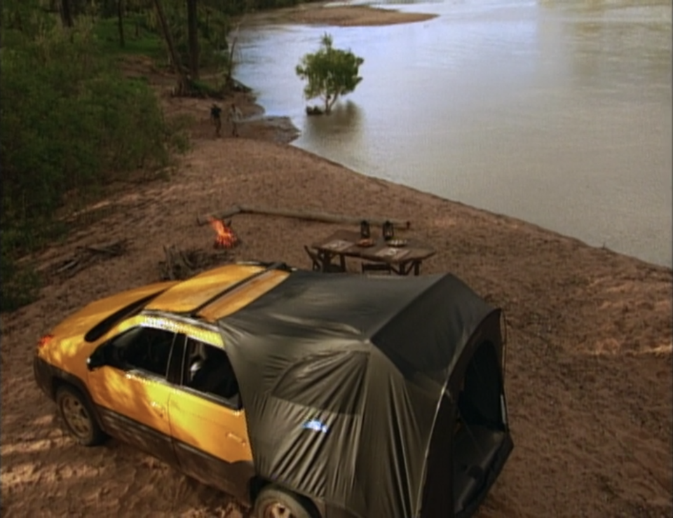 The Pontiac Aztek parked alongside a river