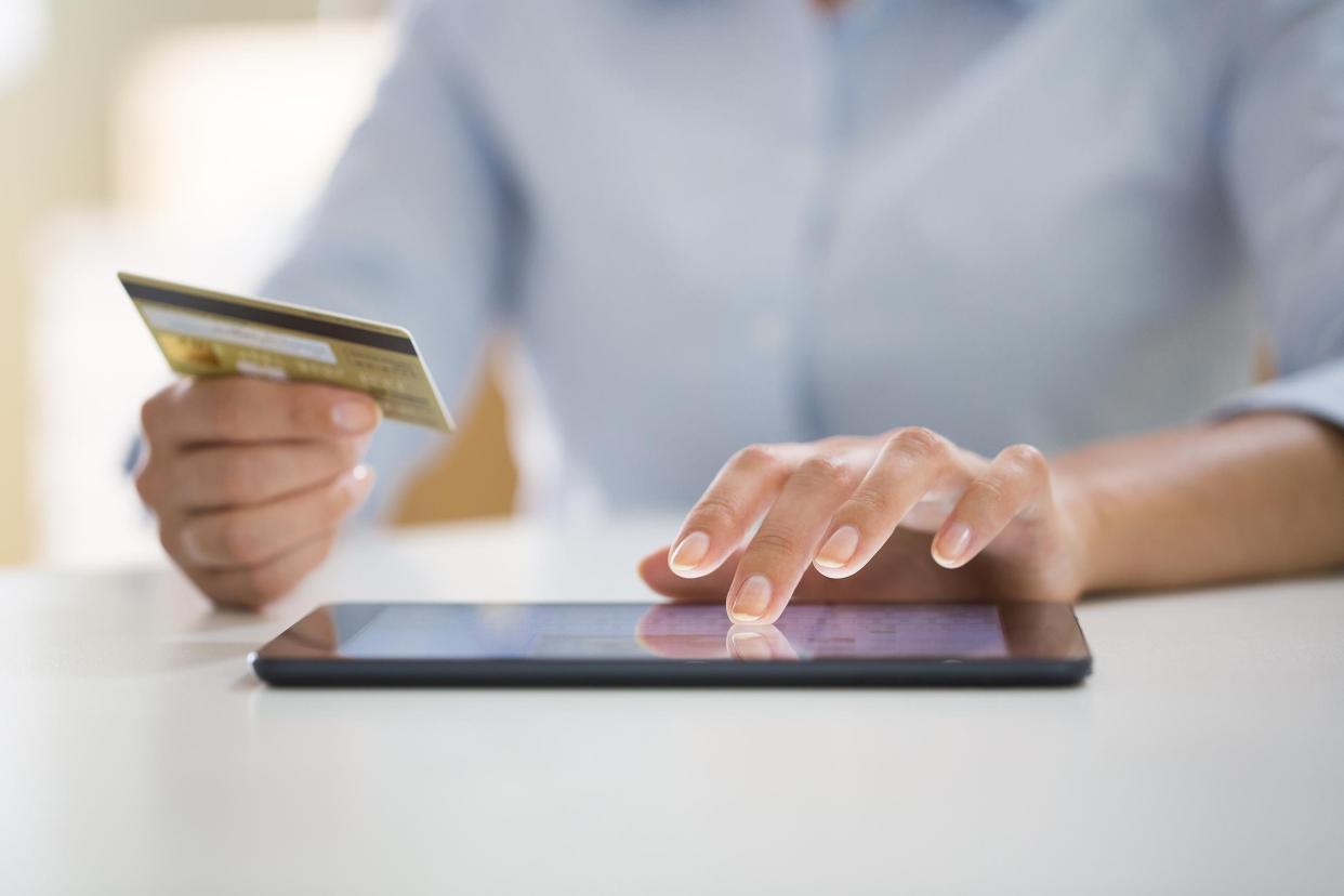 woman is shopping online with tablet