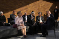 King Willem-Alexander, second right, talks to survivors and relatives after officially unveiling a new monument in the heart of Amsterdam's historic Jewish Quarter on Sunday, Sept. 19, 2021, honoring the 102,000 Dutch victims of the Holocaust. Designed by Polish-Jewish architect Daniel Libeskind, the memorial is made up of walls shaped to form four Hebrew letters spelling out a word that translates as "In Memory Of." The walls are built using bricks each of which is inscribed with the name of one of the 102,000 Jews, Roma and Sinti who were murdered in Nazi concentration camps during World War II or who died on their way to the camps. (AP Photo/Peter Dejong)