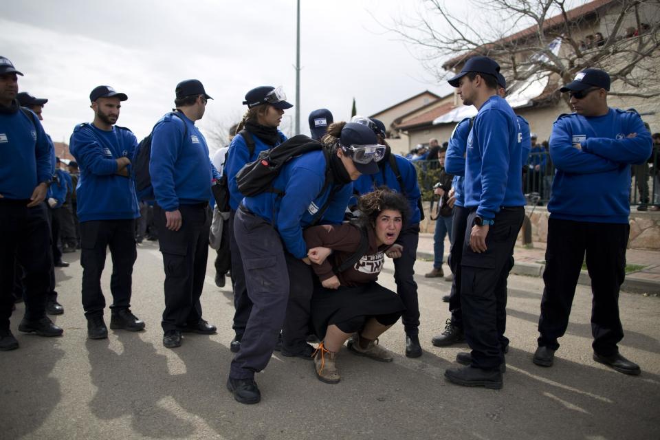 Israeli police evicts a settler from the West Bank settlement of Ofra, Tuesday, Feb. 28, 2017. Israeli forces began evacuating nine homes in the settlement following a Supreme Court decision that ruled they were built on private Palestinian land. (AP Photo/Oded Balilty)