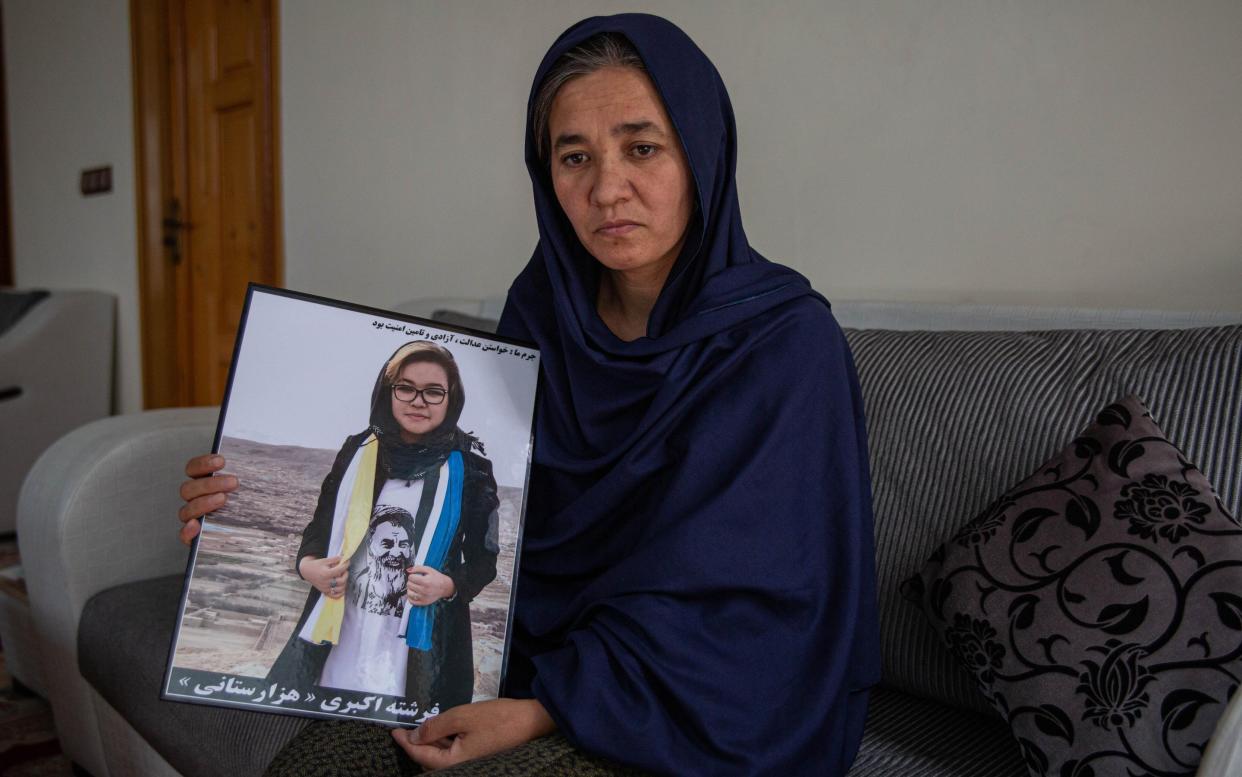 Shukria Akbari, 40, holds a picture of her 18-year-old daughter Fereshta, who was killed by a suicide bomber - Stefanie Glinkski