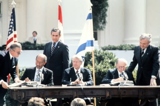 Anwar Sadat (left) and Menachem Begin (right) signing the Israel-Egypt Peace Treaty in Washington in the presence of Jimmy Carter (centre) on March 26, 1979