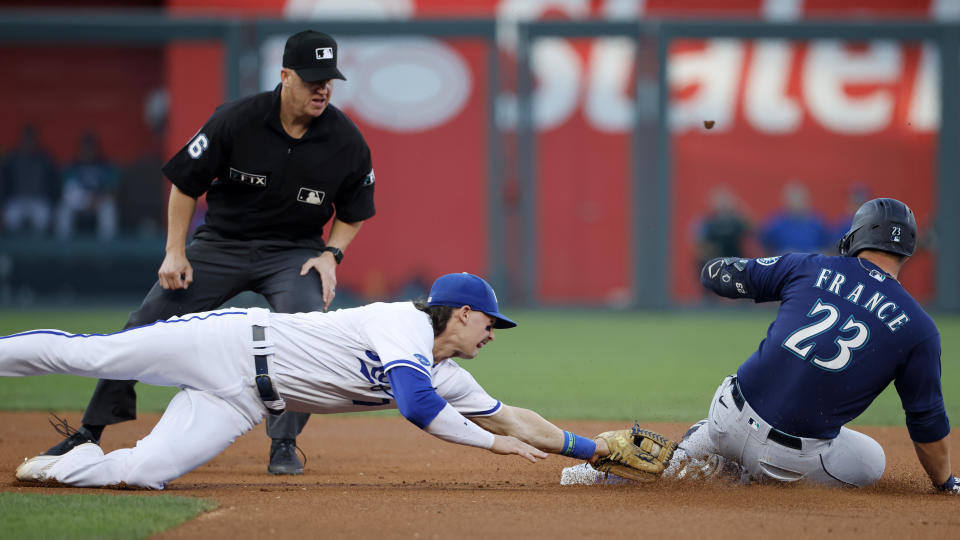 Seattle Mariners' Ty France (23) is safe with a double as Kansas City Royals shortstop Bobby Witt Jr. (7) is too late reaching for the tag during the first inning of a baseball game in Kansas City, Mo., Saturday, Sept. 24, 2022. Making the call is umpire Ryan Blakney. (AP Photo/Colin E. Braley)