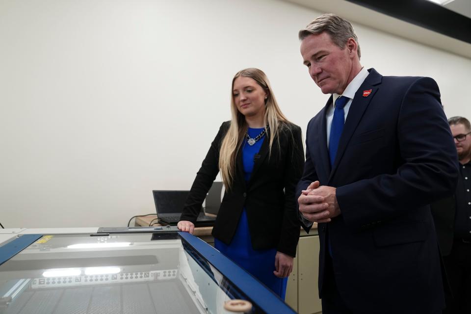 Johnstown-Monroe High School junior Yuli Staneart shows off a laser engraving machine to Lt. Gov. Jon Husted during the Monday grand opening of the school’s Innovation Lab sponsored by Meta.