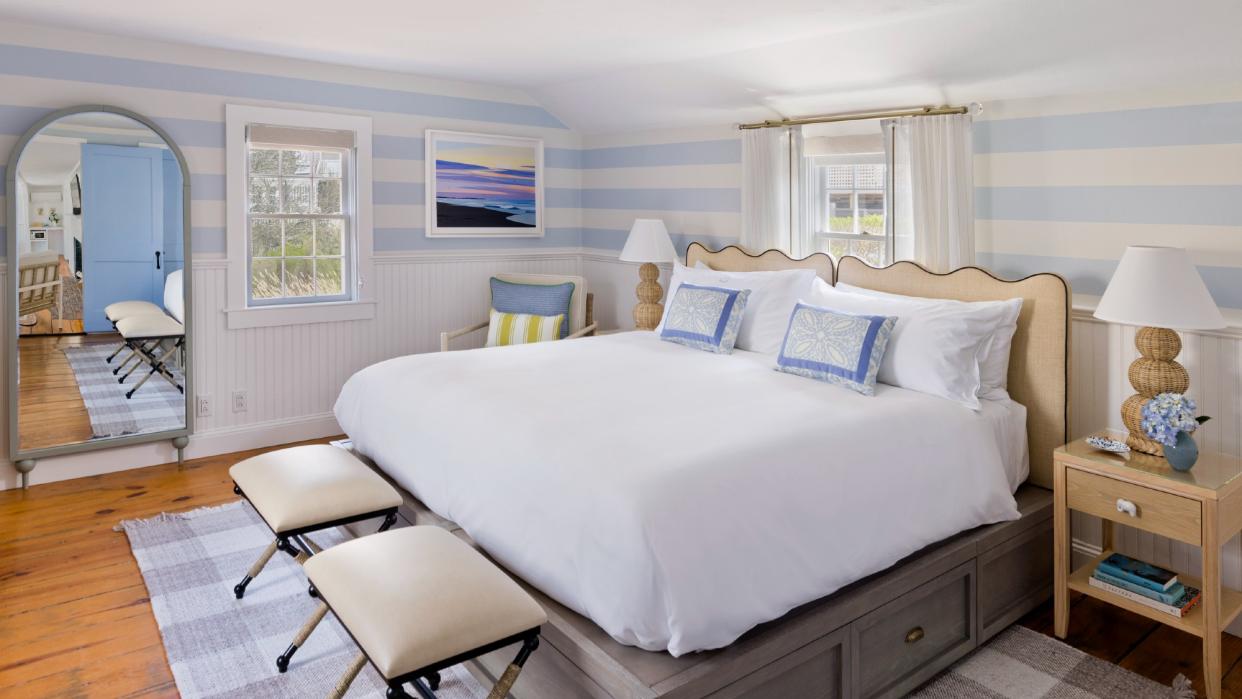  A room at the White Elephant Nantucket with a white bed and blue accents. 