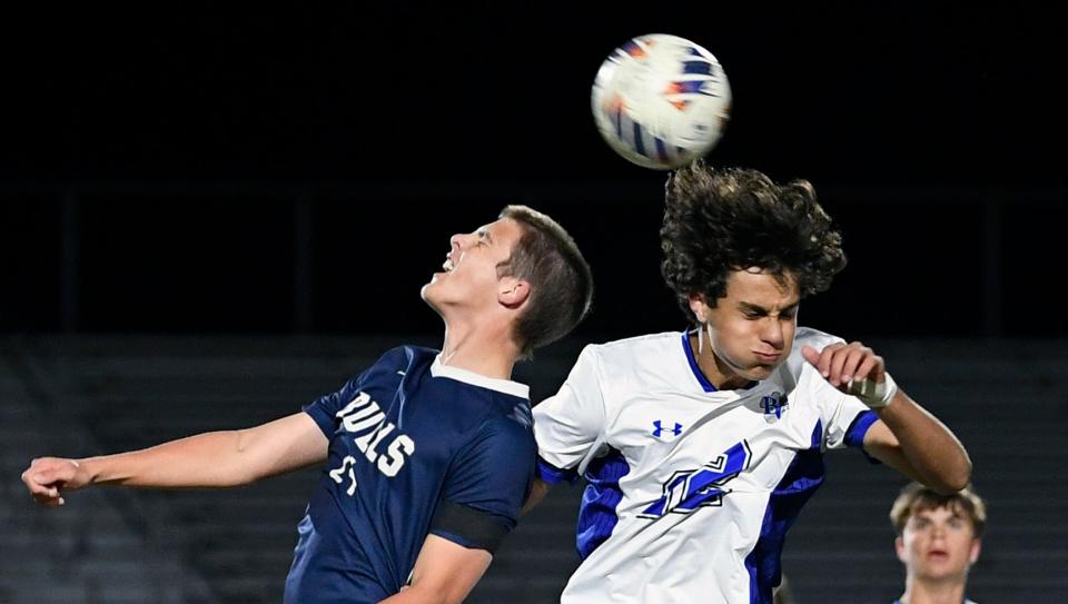 Parrish Community's (Parrish, FL) Martin Gallo (#24) and Barron Collier's (Naples, FL), Logan Tsopanoglou (#22) headers the ball during the game as Parrish hosted Tuesday's playoff game losing to Barron by a score of 5-0.