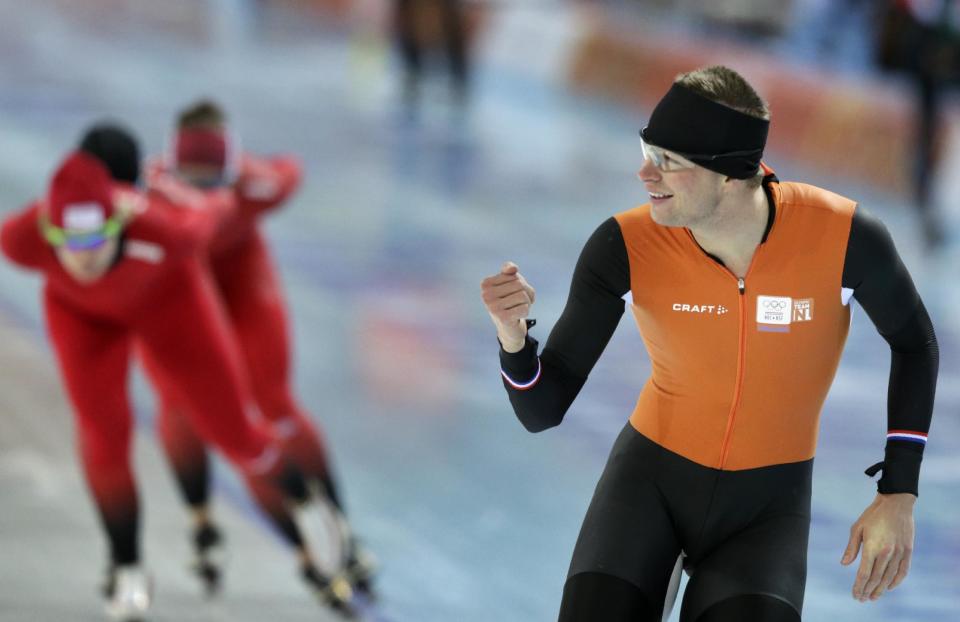 Speedskater Sven Kramer of the Netherlands gestures to a teammate as he trains at the Adler Arena Skating Center during the 2014 Winter Olympics in Sochi, Russia, Wednesday, Feb. 5, 2014. (AP Photo/Matt Dunham)