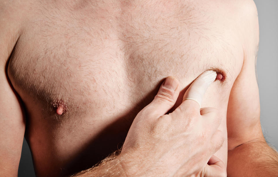 Man squeezing breast with finger