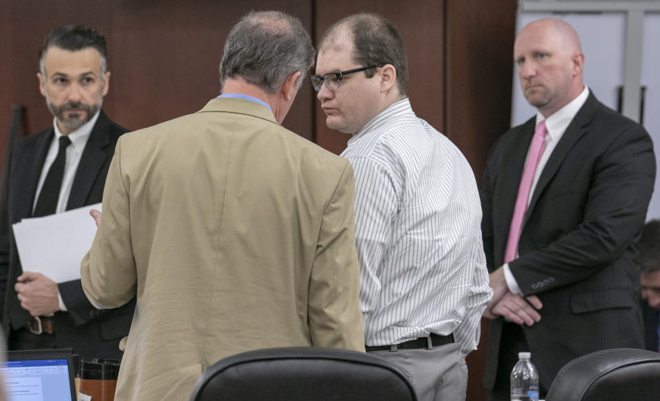 Defense attorney Boyd Young talks with Tim Jones, center, during the sentencing phase of his trial in Lexington, S.C. Timothy Jones, Jr. was found guilty of killing his 5 young children in 2014. (Tracy Glantz/The State via AP, Pool)