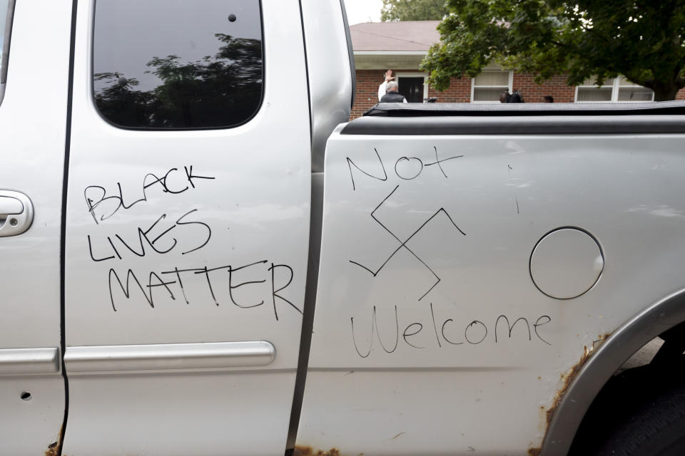 Graffiti with racial threats can be seen on a truck belonging to Eddie Hall Jr. and his wife Candace in front of their Warren, Mich., home on Thursday, Sept. 10, 2020. An arrest has been made in connection with vandalism and shots fired into the couple's home. Warren Police Commissioner Bill Dwyer confirmed the arrest Tuesday night, Sept. 29 but didn't elaborate on charges or the person arrested. (David Guralnick/Detroit News via AP)