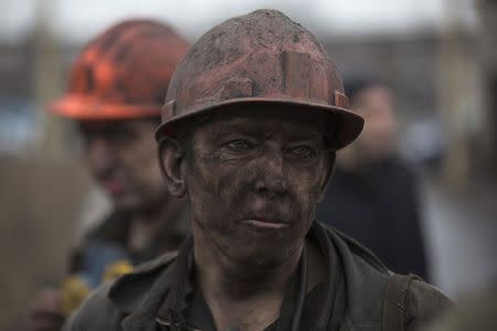 A miner waits for a bus after leaving Zasyadko coal mine in Donetsk March 4, 2015. REUTERS/Baz Ratner