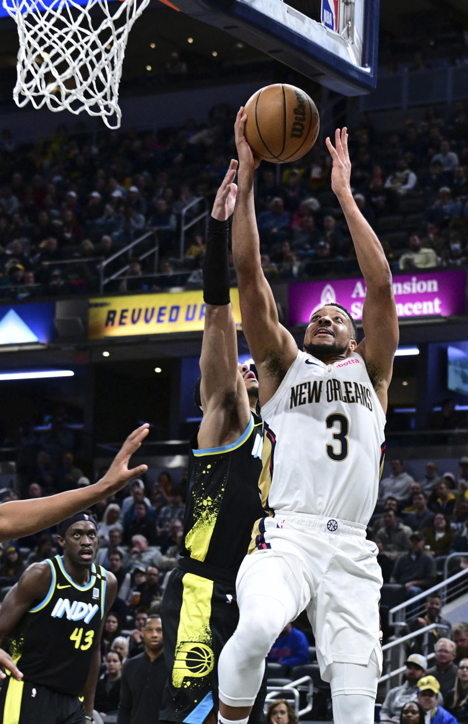 New Orleans Pelicans guard CJ McCollum (3) shoots the ball in front of Indiana Pacers guard Andrew Nembhard during the second half of an NBA basketball game Wednesday, Feb. 28, 2024, in Indianapolis. (AP Photo/Marc Lebryk)