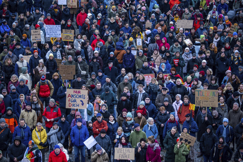 Participants in a demonstration against right-wing extremism under the slogan "Never again is now - all together against fascism" gather on Neuer Markt in front of the town hall in Rostock, Germany, Saturday Feb. 10, 2024. Germany's Interior Minister Nancy Faeser said Tuesday Feb. 13, 2024 that she aims to make it easier to trace right-wing extremists' financing and plans to set up an “early recognition unit” to detect far-right and foreign disinformation campaigns as early as possible. (Jens Büttner/dpa via AP)