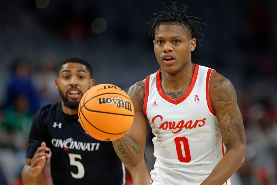 Houston guard Marcus Sasser brings the ball up the court ahead of Cincinnati guard David DeJulius during the first half in the semifinals of the American Athletic Conference Tournament, Saturday, March 11, 2023, in Fort Worth, Texas