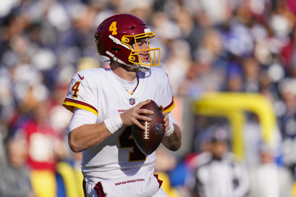 Washington Football Team quarterback Taylor Heinicke looks to pass against the Dallas Cowboys during the first half of an NFL football game, Sunday, Dec. 12, 2021, in Landover, Md. (AP Photo/Julio Cortez)