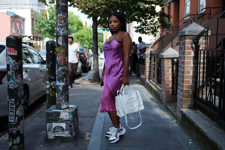 Nia Indigo, 23, a stylist based in New York, poses for a picture wearing a pair of Louis Vuitton Archlight sneakers in the Brooklyn borough of New York, U.S., September 2, 2018. REUTERS/Caitlin Ochs