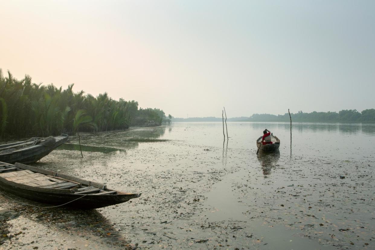 <span>A villager on Bangladesh’s Shakbaria River. Koyra, in Khulna district, borders the Sundarbans, the world’s largest mangrove forest and home to more than 100 Bengal tigers. Widows are supposed to get compensation after tiger attacks but the money is hard to claim. </span><span>Photograph: Farzana Hossen/The Guardian</span>