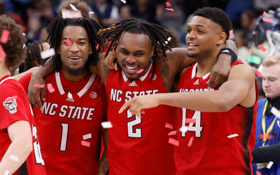 N.C. State’s Jayden Taylor (1), Kam Woods (2) and Casey Morsell (14) celebrate after N.C. State’s 84-76 victory over UNC in the championship game of the 2024 ACC Men’s Basketball Tournament at Capital One Arena in Washington, D.C., Saturday, March 16, 2024.