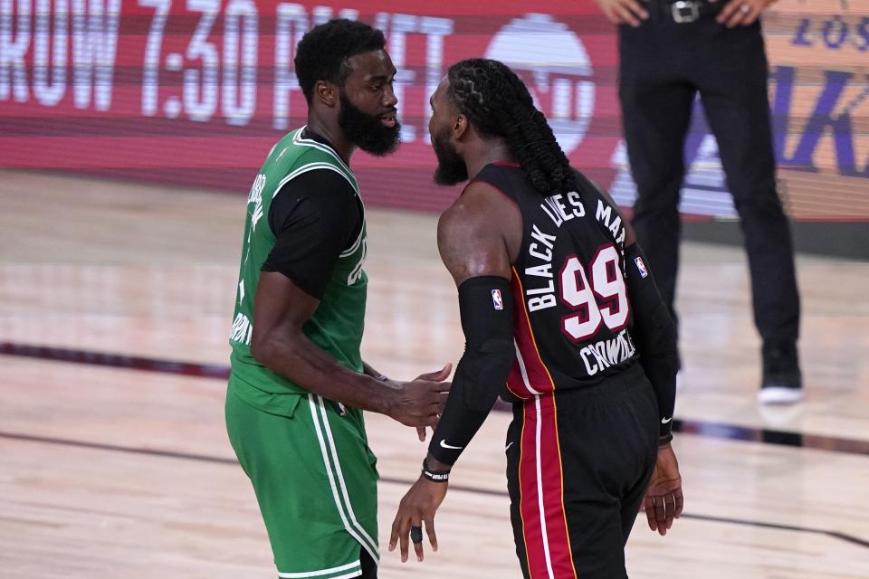 Boston Celtics' Jaylen Brown, left, and Miami Heat's Jae Crowder (99) exchange words during the second half of an NBA conference final playoff basketball game, Saturday, Sept. 19, 2020, in Lake Buena Vista, Fla. (AP Photo/Mark J. Terrill)