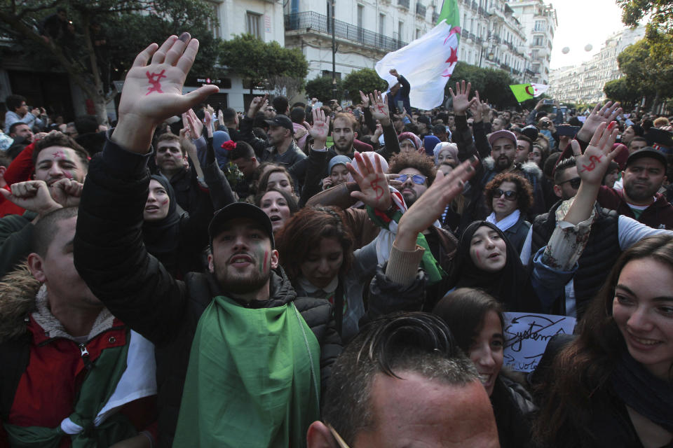 Algerian demonstrators take to the streets in the capital Algiers to reject the presidential elections, in Algeria, Thursday, Dec. 12, 2019. Five candidates have their eyes on becoming the next president of Algeria _ without a leader since April _ in Thursday's contentious election boycotted by a massive pro-democracy movement. (AP Photo/Fateh Guidoum)