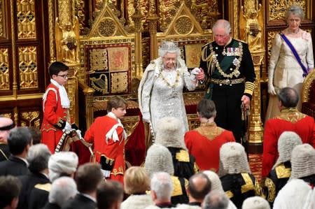 Britain's Queen Elizabeth leaves with Charles, Prince of Wales after delivering the Queen's Speech during the State Opening of Parliament in London