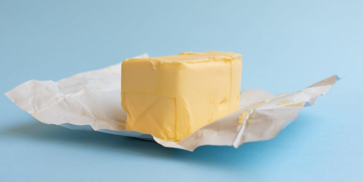 close up of butter on blue background