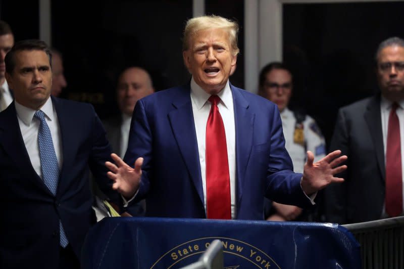 Former U.S. President Donald Trump speaks from the hallway outside a courtroom where he is attending a hearing in his criminal case on charges stemming from hush money paid to a porn star in New York City on Monday. Pool Photo by Spencer Platt/UPI