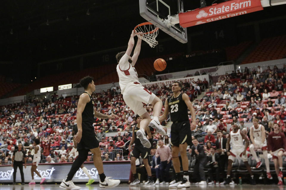 Washington State center Oscar Cluff dunks during the second half of an NCAA college basketball game against Colorado, Saturday, Jan. 27, 2024, in Pullman, Wash. Washington State won 78-69. (AP Photo/Young Kwak)