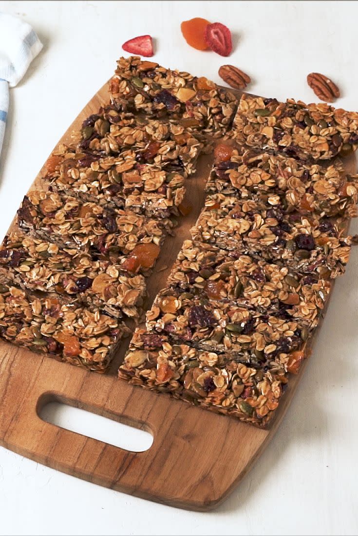 <p>These are so easy to make at home, <em>and</em> you can control what goes in them! Switch this recipe up with your favorite nuts or dried fruits. Just make sure to chop large nuts or fruit into small pieces - this helps keep the granola bars together.</p><p>Get the <strong><a href="https://www.delish.com/cooking/recipe-ideas/a34211178/homemade-granola-bars-recipe/" rel="nofollow noopener" target="_blank" data-ylk="slk:Homemade Granola Bars recipe;elm:context_link;itc:0;sec:content-canvas" class="link ">Homemade Granola Bars recipe</a></strong>.</p>