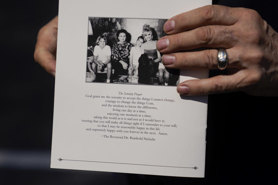 R. Couri Hay, longtime friend of Ivana Trump, holds a program from her funeral Mass, Wednesday, July 20, 2022, in New York. (AP Photo/John Minchillo)