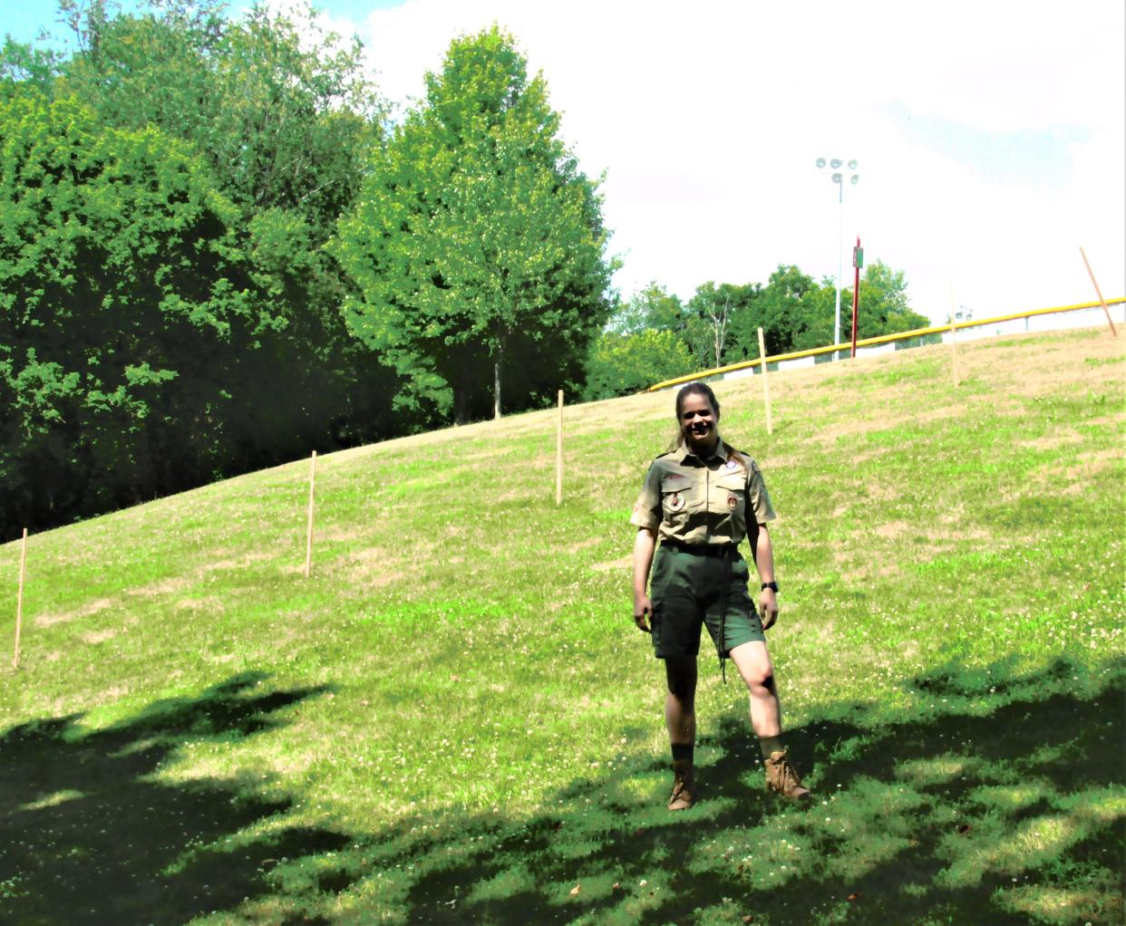 Brenna Barbey stands on the hillside where her proposed Eagle Scout project of an amphitheater has been marked off. The location is beyond the outfield fence of the Little League field at Deer Run Park.