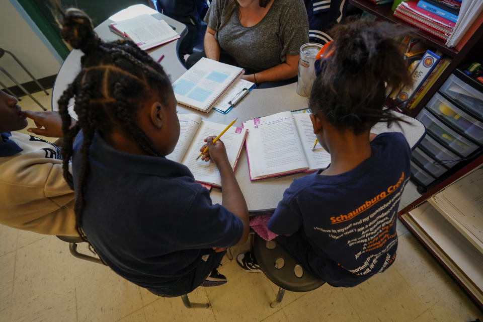 Third graders read during class at Schaumburg Elementary, part of the ReNEW charter network, in New Orleans, Wednesday, April 19, 2023. (AP Photo/Gerald Herbert)