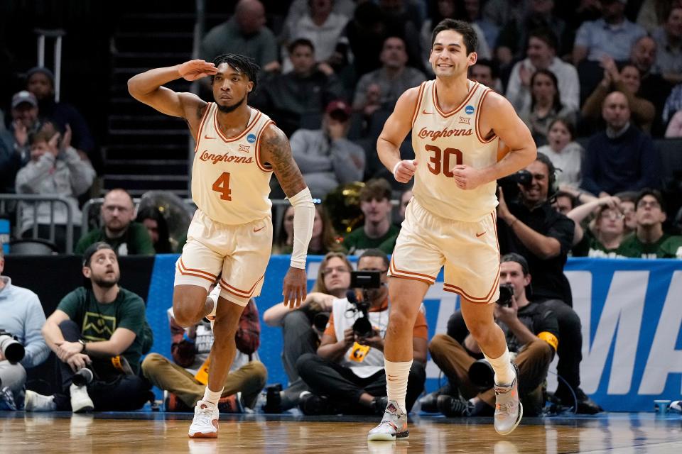 Texas guard Tyrese Hunter, left, and forward Brock Cunningham celebrate a basket during the first half of the Longhorns' 56-44 win over Colorado State in the first round of the NCAA Tournament on Thursday night in Charlotte, N.C. The Horns will play No. 2-seeded Tennessee in the second round Saturday night.