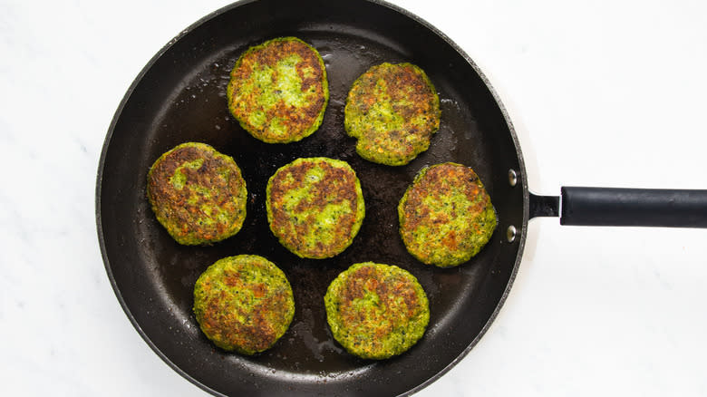broccoli fritters frying in pan