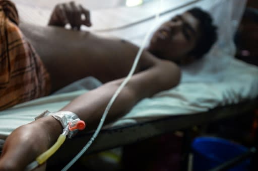 A Bangladeshi man suffering from dengue fever receives treatment at the Shaheed Suhrawardy Medical College and Hospital in Dhaka