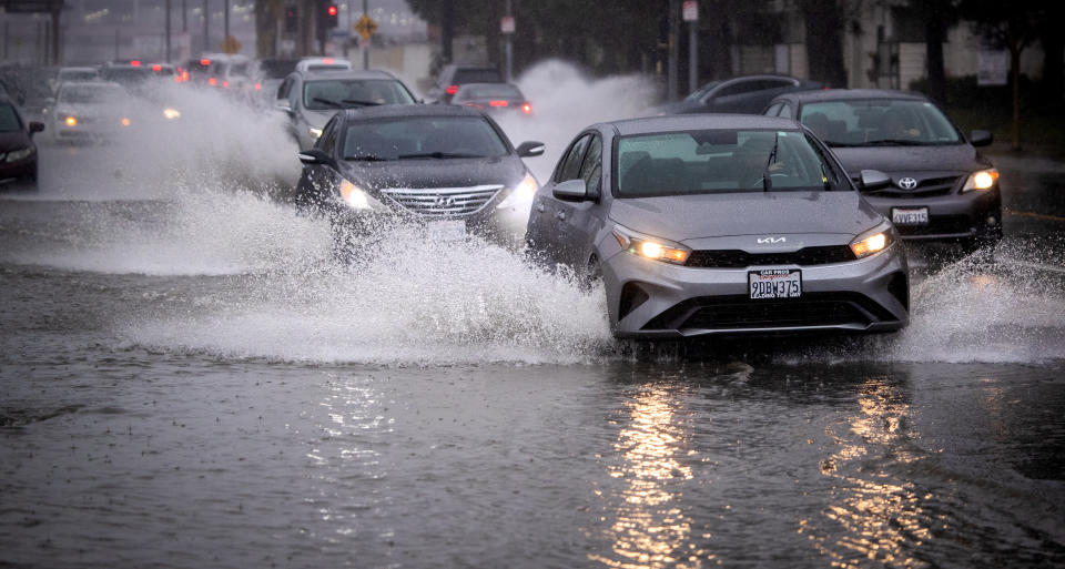 Motorists drive through a flooded area of Vanowen Street in North Hollywood 