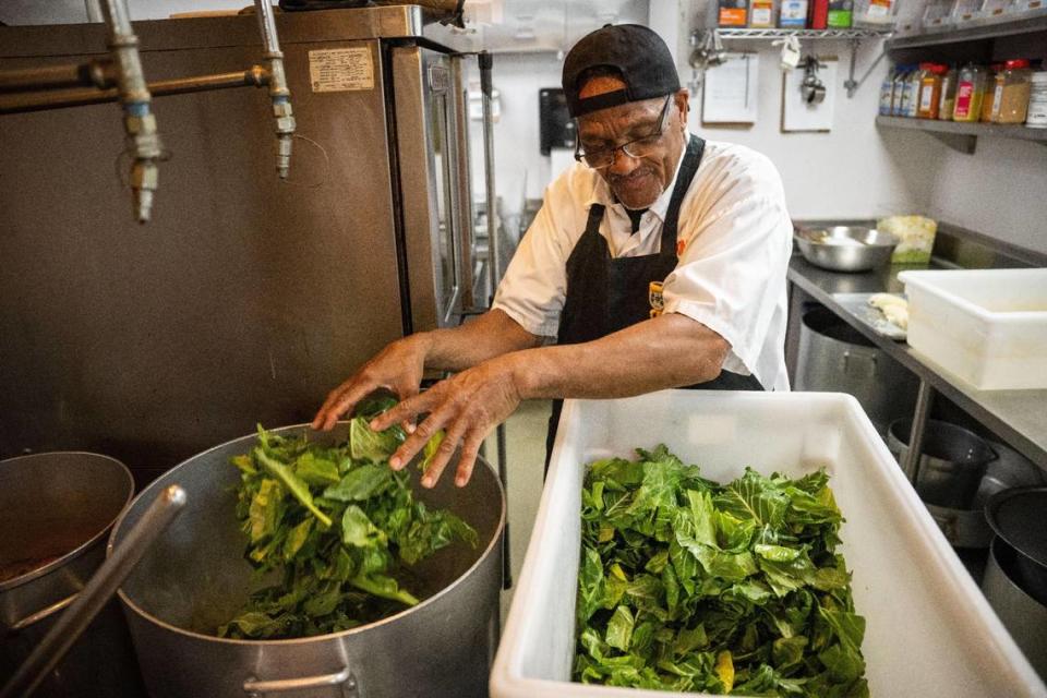 Ran Williams fills a pot with collard greens in July at Fixins Soul Kitchen.