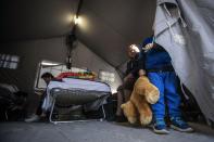 <p>A child holds a stuffed toy as other people sit in a tent set up following Wednesday’s earthquake, in Amatrice, central Italy, Thursday, Aug. 25, 2016.(Angelo Carconi/ANSA via AP) </p>