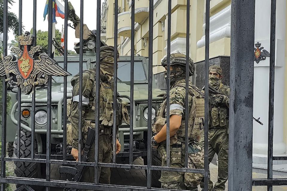 FILE - Servicemen of the Wagner Group military company guard an area at the headquarters of the Southern Military District in Rostov-on-Don, Russia, Saturday, June 24, 2023. Wagner leader Yevgeny Prigozhin incited a rebellion against Russia's military leaders and marched with his troops toward Moscow but aborted his mutiny when Belarusian President Alexander Lukashenko brokered an agreement that included exile for the warlord in Belarus. (AP Photo, File)