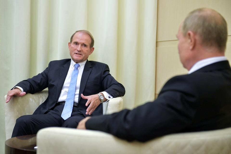 FILE Ukrainian tycoon Viktor Medvedchuk, left, speaks to Russian President Vladimir Putin during a meeting at the Novo-Ogaryovo residence outside Moscow, Russia, Tuesday, Oct. 6, 2020. As a political novice running to be Ukraine’s president, Volodymyr Zelenskyy vowed to reach out to Russia-backed rebels in the east who were fighting Ukrainian forces and make strides toward resolving the conflict. The assurances contributed to his landslide victory in 2019(Sputnik, Kremlin Pool Photo via AP, File)