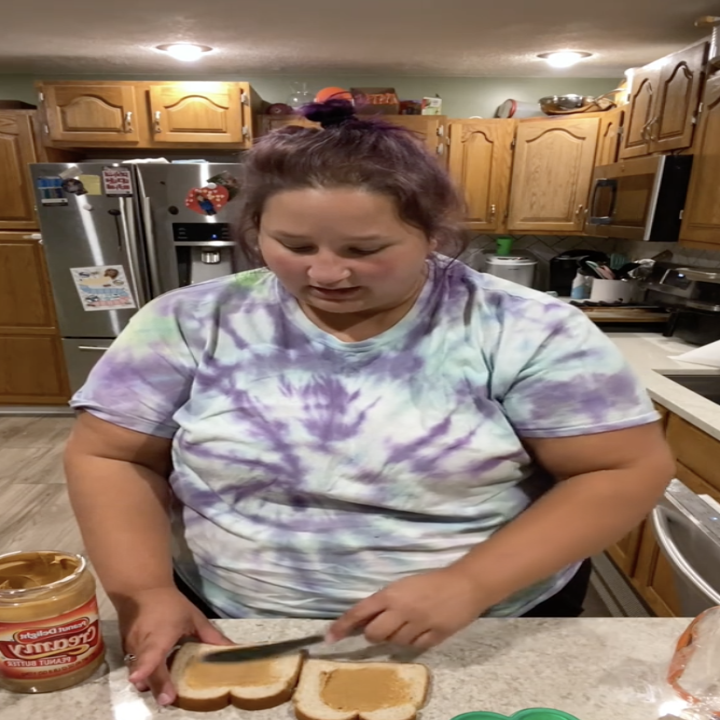 jessica spreading peanut butter on two slices of white bread