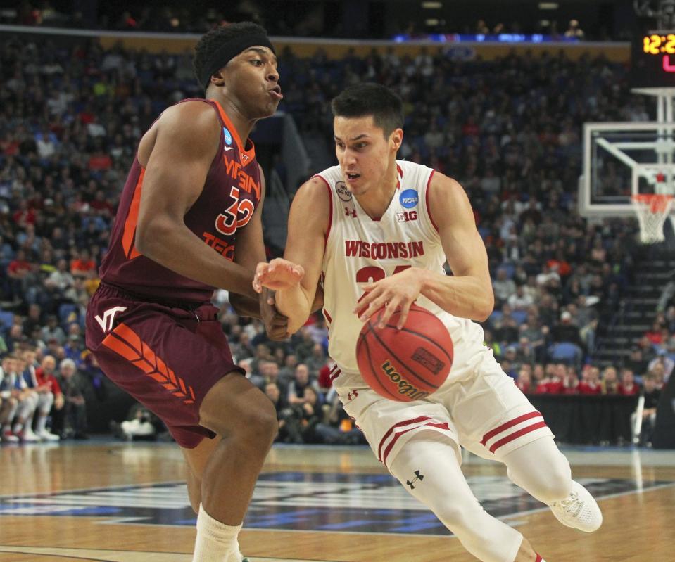 Wisconsin guard Bronson Koenig (24) drives to the basket against Virginia Tech forward Zach LeDay (32) during the first half of a first-round men's college basketball game in the NCAA Tournament, Thursday, March 16, 2017, in Buffalo, N.Y. (AP Photo/Bill Wippert)