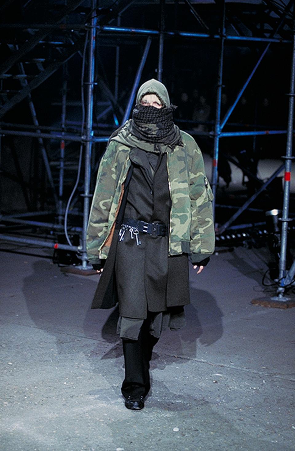 Tactical clothes are trending, from Louis Vuitton to Alyx. We're tracing the trend back to Helmut Lang, Raf Simons, and our troubled times.