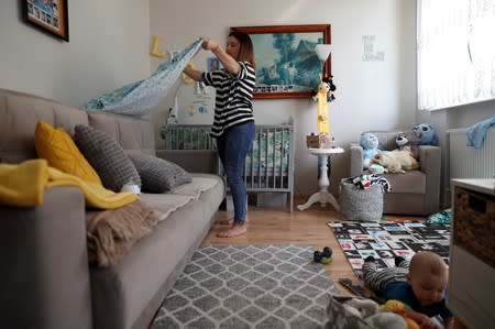 Karolina Burczyk is pictured with her son Leon in her home in Nowa Karczma